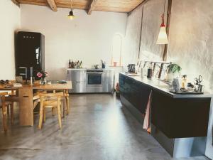 a large kitchen with a table and a dining room at Gladeholm - Kivik - artist studio in Kivik