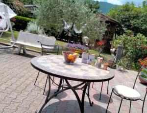 a table with a bowl of fruit on a patio at B&B Santa Maria in Forino