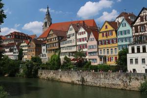 a group of colorful buildings next to a river at Gästezimmer bei Ingrid in Tübingen