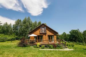 a log cabin in a field with trees at Shanti House in Migovo