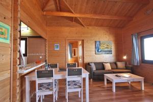 a living room with a table and a couch at Bungalow Moijama el Drago in Los Llanos de Aridane