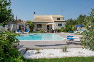 a villa with a swimming pool and a house at Corfu Villa Linea in Línia
