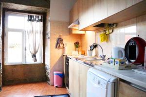 a kitchen with a sink and a window at Casa do Adro- Douro in Peso da Régua