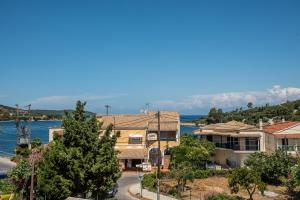 a view of a house and the water at Eva Studios in Kassiopi