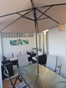 a glass table and chairs in a room at Casa del Sol in Manilva