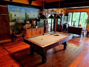 a pool table in the middle of a room at La Toscana Rustica in Muşeteşti