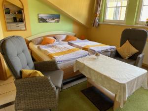 a bedroom with a bed and a table and chairs at Haus Simon in Blankenrath