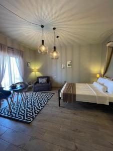 een slaapkamer met een bed, een bank en een tafel bij Fiore di Flora in Archangelos
