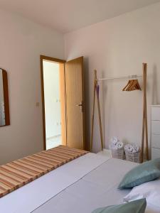 a bedroom with a bed and a closet and a door at Apartmani Tomelić in Orebić