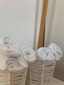 a basket filled with towels sitting on a table at Apartmani Tomelić in Orebić