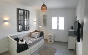 a bedroom with a bed and a tv in a room at Romantic Casa del Mar in Costa Teguise