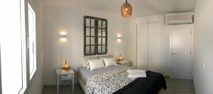 a bedroom with a bed and two lamps and a window at Romantic Casa del Mar in Costa Teguise