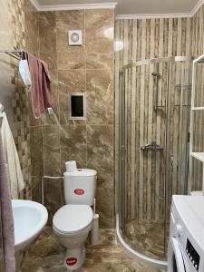 a bathroom with a toilet and a sink and a shower at Apartments Pomorie Tundzha 9 in Pomorie