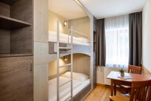 A bed or beds in a room at JUFA Hotel Eisenerzer Ramsau