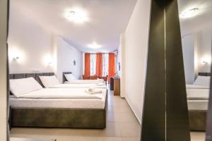 Letto o letti in una camera di Tino Hotel & SPA