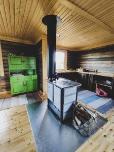 a stove in a room with a wooden ceiling at Polar Lights Lodge in Sirkka