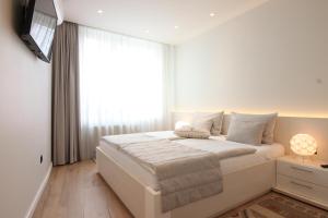 Postel nebo postele na pokoji v ubytování Sarajevo Daily Apartments