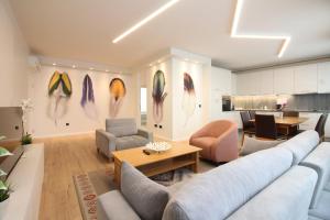 a living room with a couch and chairs and a table at Sarajevo Daily Apartments in Sarajevo