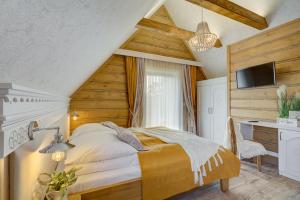 Schlafzimmer mit einem Bett und einem Schreibtisch in der Unterkunft Domki Małe Ciche in Małe Ciche