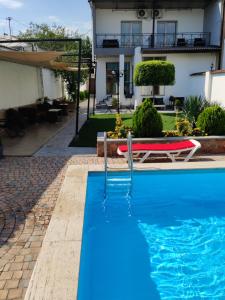 a swimming pool in front of a house at Garden Lounge Hotel in Yerevan