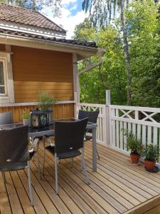 a patio with chairs and a table on a deck at Rauhaa, hyvää unta maaseudulla in Loppi