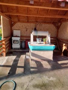 an outdoor patio with a stove and a oven at Casa Anhela in Corbu