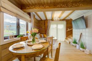a dining room with a table and chairs at Domki Małe Ciche in Małe Ciche