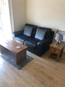 a living room with a couch and a coffee table at Nook and Harbour Holiday Apartments & rooms in Weston-super-Mare