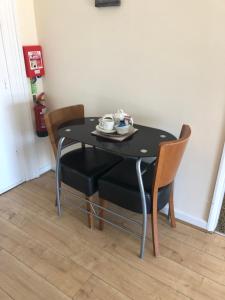 a wooden table in a room with a wooden floor at Nook and Harbour Holiday Apartments & rooms in Weston-super-Mare