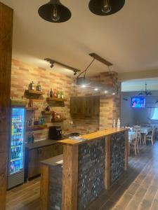 a kitchen with a bar and a dining room at Grádics Panzió in Siculeni