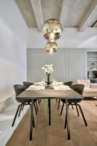 a dining room with a table and chairs at 10 Strait Street Apartments in Valletta +40 photos