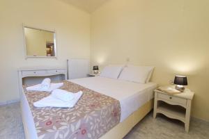 A bed or beds in a room at The Sunset Villa Kefalonia