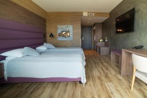 Postel nebo postele na pokoji v ubytování Hotel Kriunes