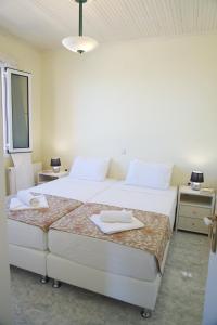 A bed or beds in a room at The Sunset Villa Kefalonia