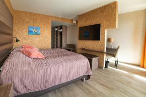 Postel nebo postele na pokoji v ubytování Hotel Kriunes