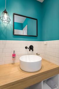 a bathroom with a white sink and a mirror at Kouros Hill in Xirokástellon