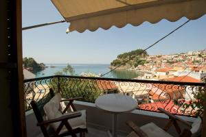 a balcony with a view of a city and the ocean at Olympic Apartments in Parga