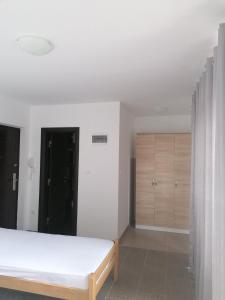 a bedroom with a bed and wooden cabinets at Promenada in Veliko Gradište