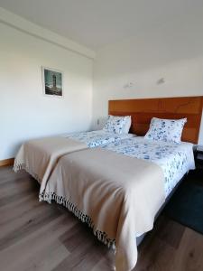 two beds sitting next to each other in a bedroom at Quinta do Areeiro in Horta