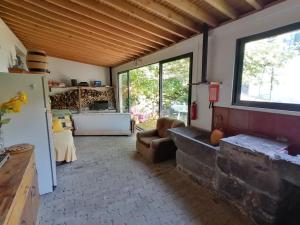 a living room with a couch and a large window at Quinta do Areeiro in Horta