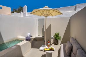 a patio with an umbrella and a pool at Coconut Residence in Karterados