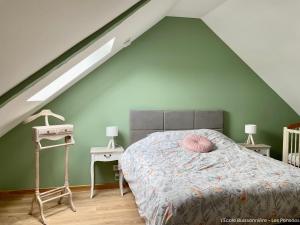 a bedroom with a bed and two night stands at L'École Buissonnière in Saint-Vigor-le-Grand