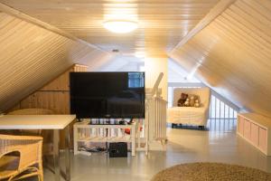 a living room with a flat screen tv and a couch at Moksula in Ähtäri