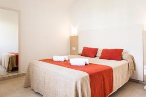 a bedroom with a large bed with two pillows on it at Sagitario Menorca Mar Adults only in Cala'n Bosch