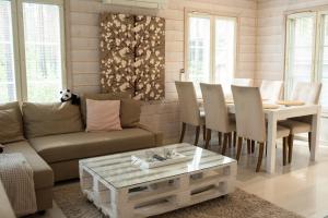 a living room with a couch and a table at Moksula in Ähtäri