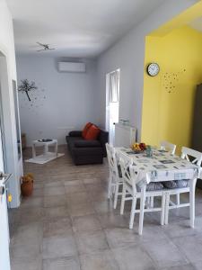 a living room with a white table and chairs at Apartman Luce in Krk
