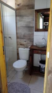 a bathroom with a toilet and a sink at Tiny House II - Sítio dos Wolff in Gravataí