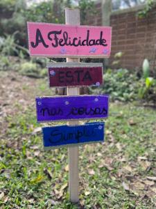 a sign with street names on it in a garden at Tiny House II - experiência de refúgio exclusivo in Gravataí +28 photos