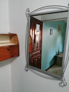 a room with a mirror and a door at Bwejuu Beach Palm Villa in Bwejuu