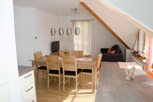a kitchen and dining room with a table and chairs at Voitsberg-Apartments in Voitsberg